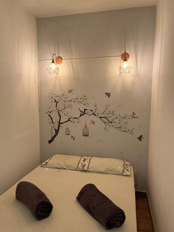 a bedroom with a bed with a tree mural at Canto do Florescer in Pesqueira