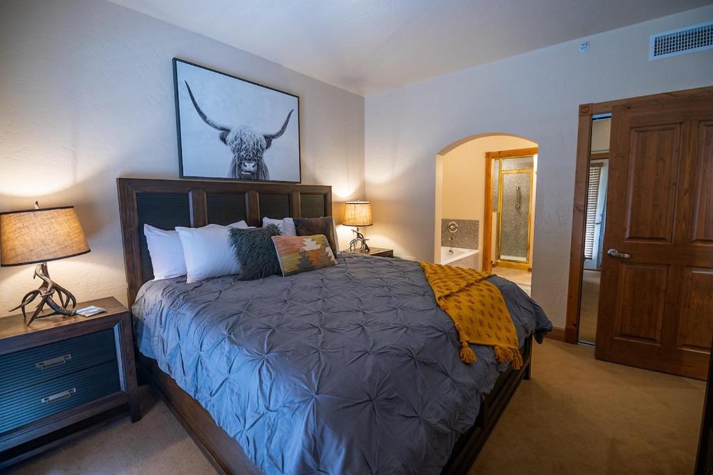 a bedroom with a bed with a deer head on the wall at Alpine-Style Zermatt King Villa with Full Kitchen Near Park City & Deer Valley Ski Resorts - 2068 in Mound City