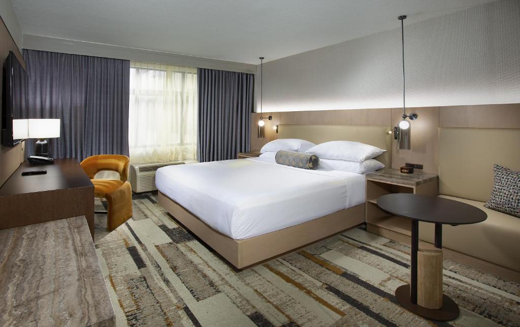 a hotel room with a large bed and a desk at The Paramount Hotel in Seattle