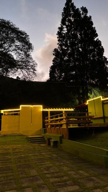 a group of benches in a park with lights at Bike Ville Fojo in Campos do Jordão