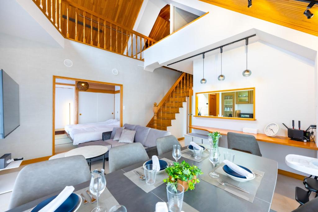 a dining room and living room with a table and chairs at Hotel Iemirai Nakano Penthouse - SHINJUKU 12min train ride in Tokyo