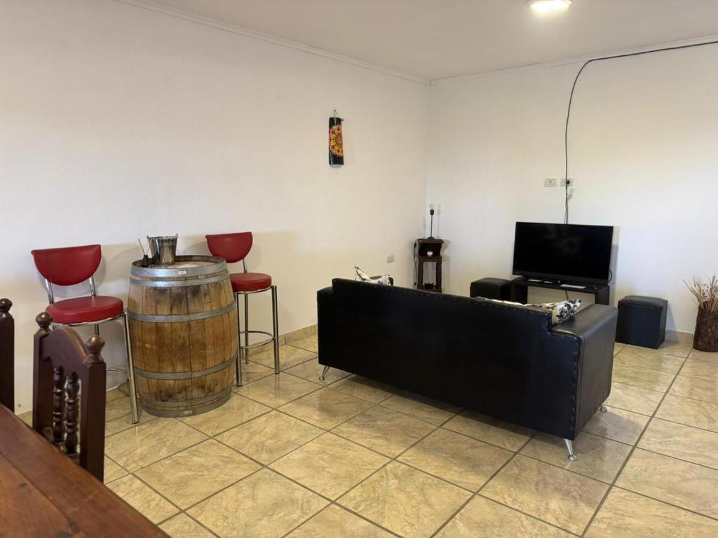 een kamer met een ton, een bank en een televisie bij La Soñada in Mercedes