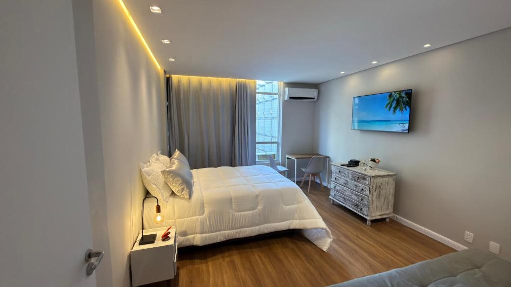 Ένα ή περισσότερα κρεβάτια σε δωμάτιο στο Apt 711 - Elegância com vista parcial do mar