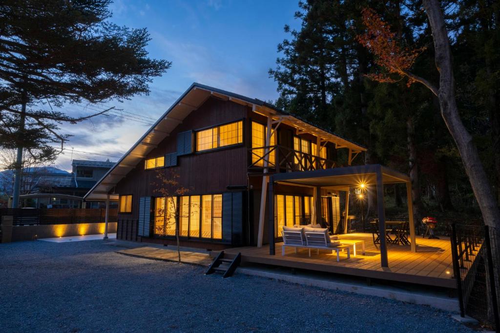 a house with a lot of windows on a deck at Nagi GIVE 日光 in Nikko