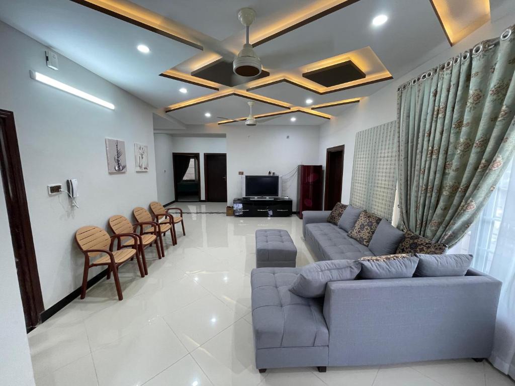 a living room with a couch and chairs at Ranim Family Lodge Abbottabad in Abbottābād