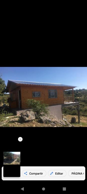 a screenshot of a home with a picture of a building at Cabaña Flor Serrana in Tanti