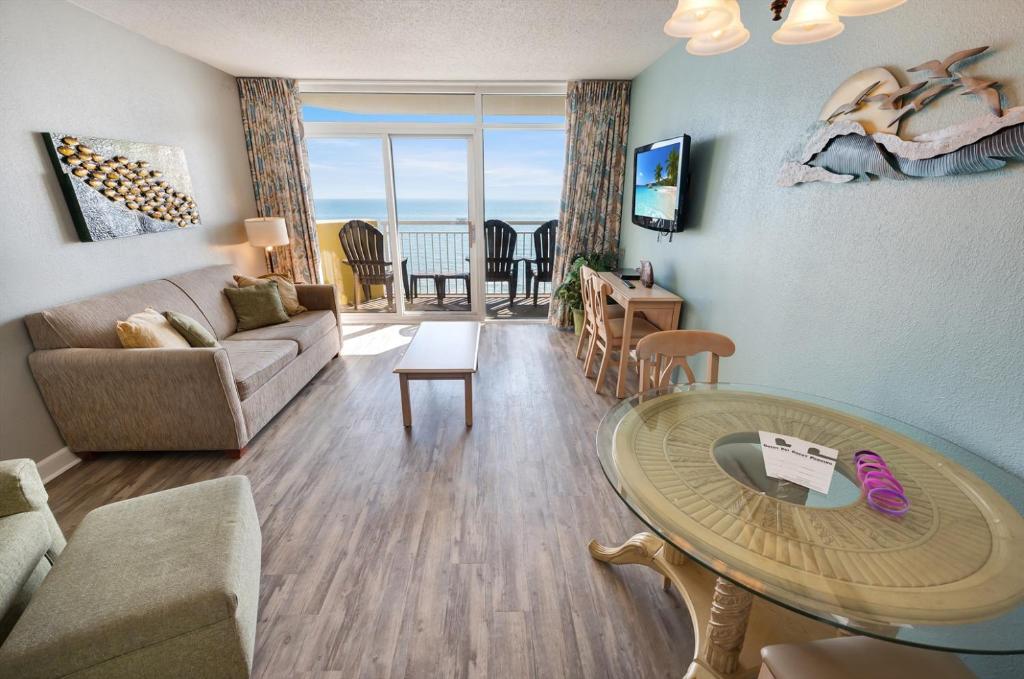 a living room with a couch and a table at Condo near Barefoot Landing w beach access in Myrtle Beach