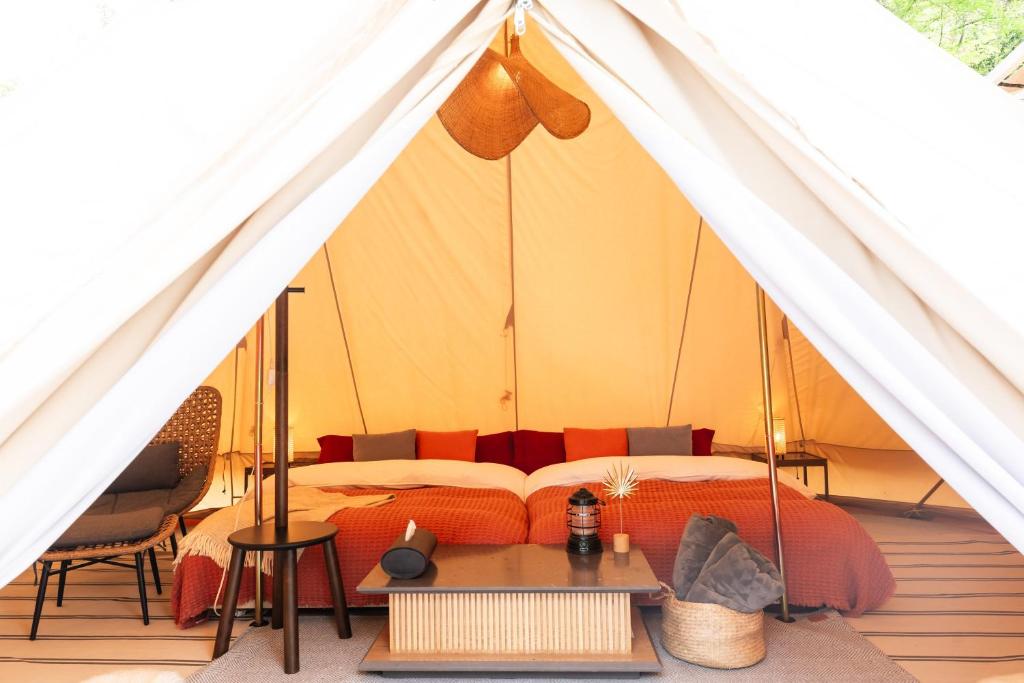 a bedroom with a bed in a tent at ザランタン鹿沼 in Kanuma