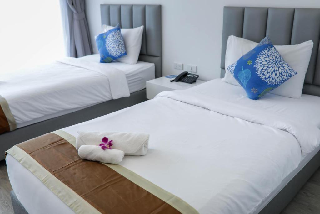 Ένα ή περισσότερα κρεβάτια σε δωμάτιο στο Baan Suan Khun Ta and Golf Resort