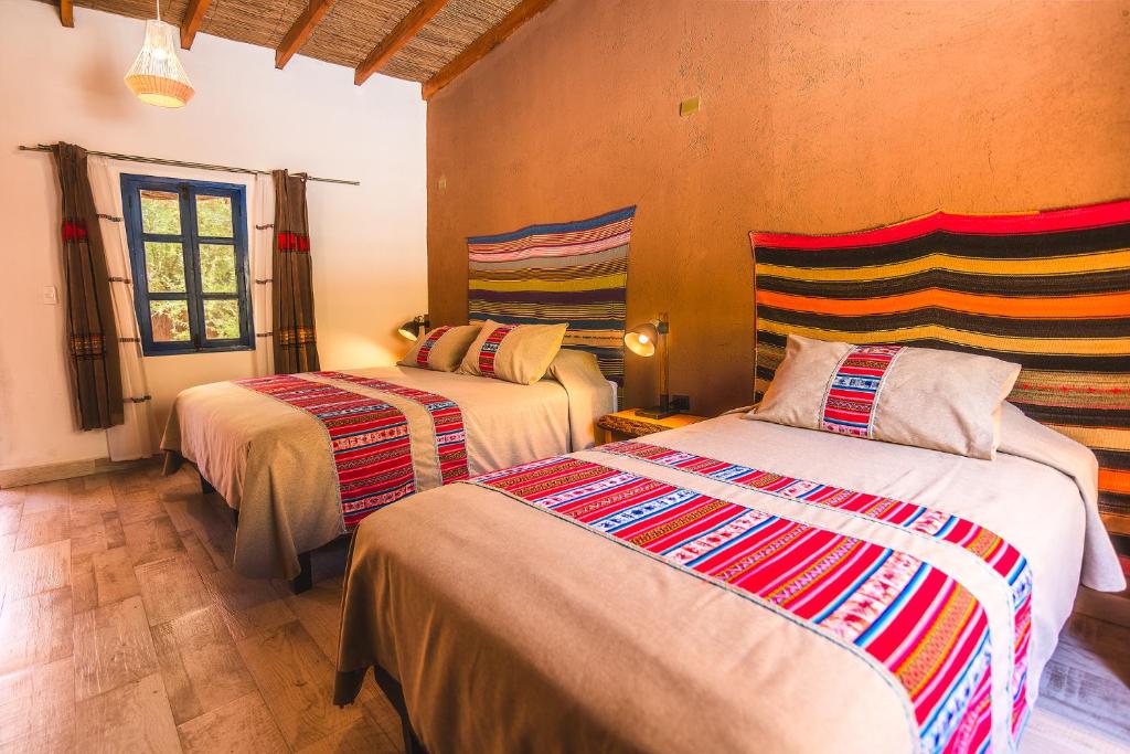 Postel nebo postele na pokoji v ubytování Ckoi Atacama Lodge