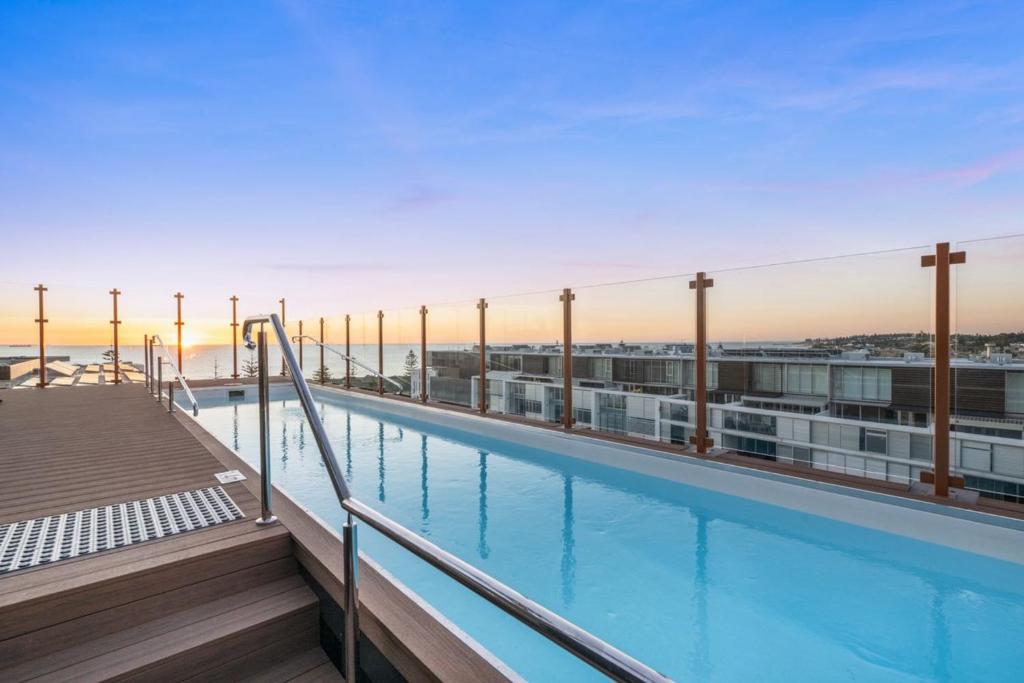 a swimming pool on the roof of a building at Coastal Apartment with Rooftop Pool in North Fremantle
