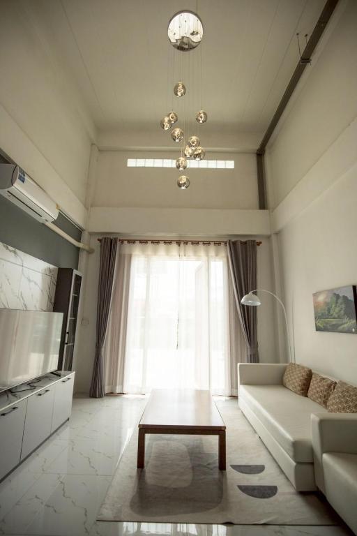 a living room with a couch and a table at Lazy shot in Ban San Ton Ko (1)