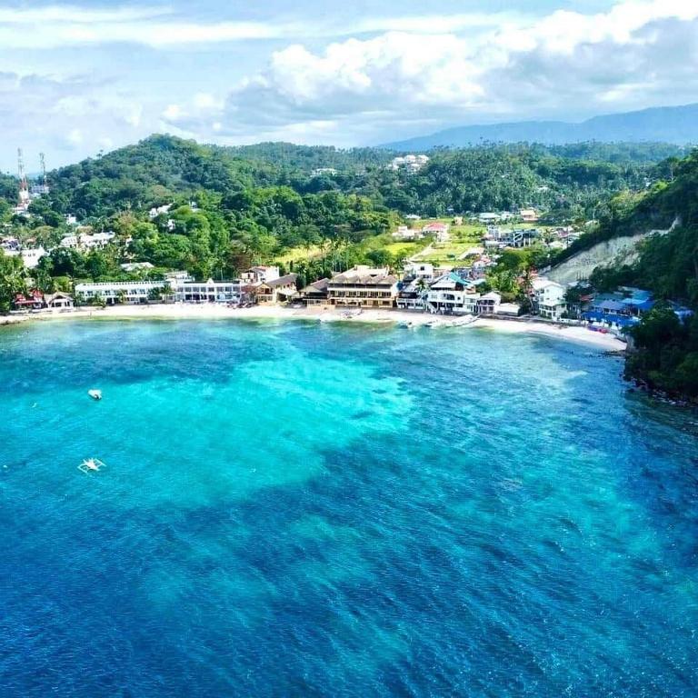 an aerial view of a beach with turquoise water at Campbells Beach Resort in Puerto Galera