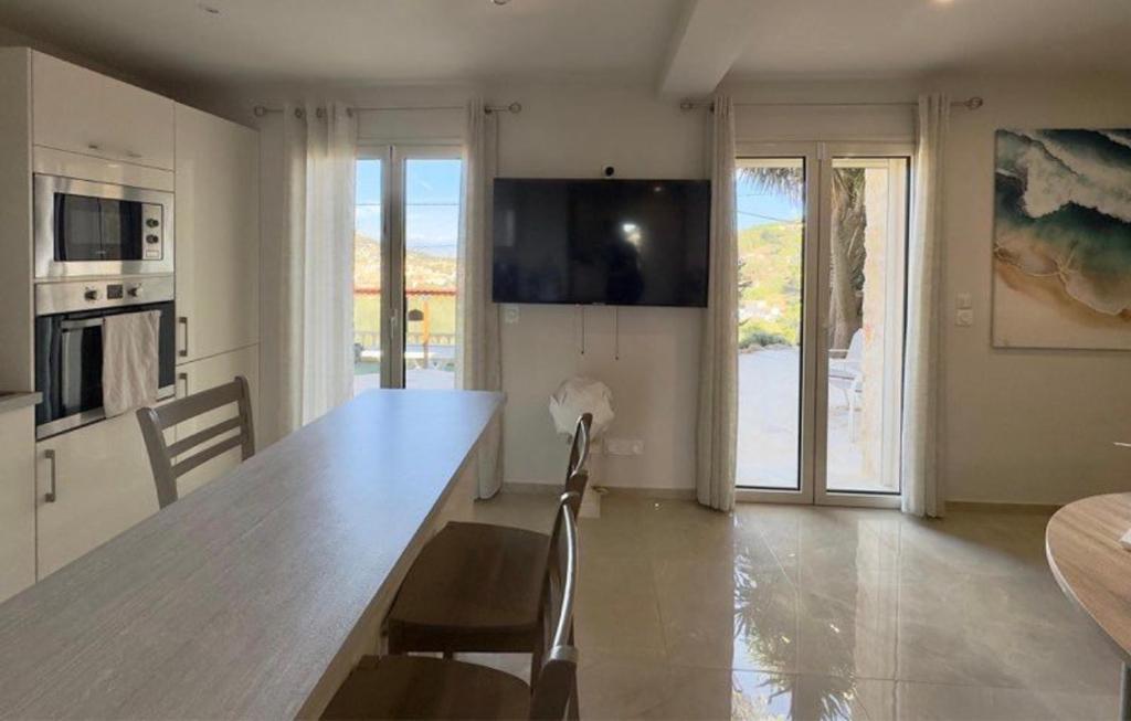 a kitchen with a large wooden table and chairs at Eryvazur in Vallauris
