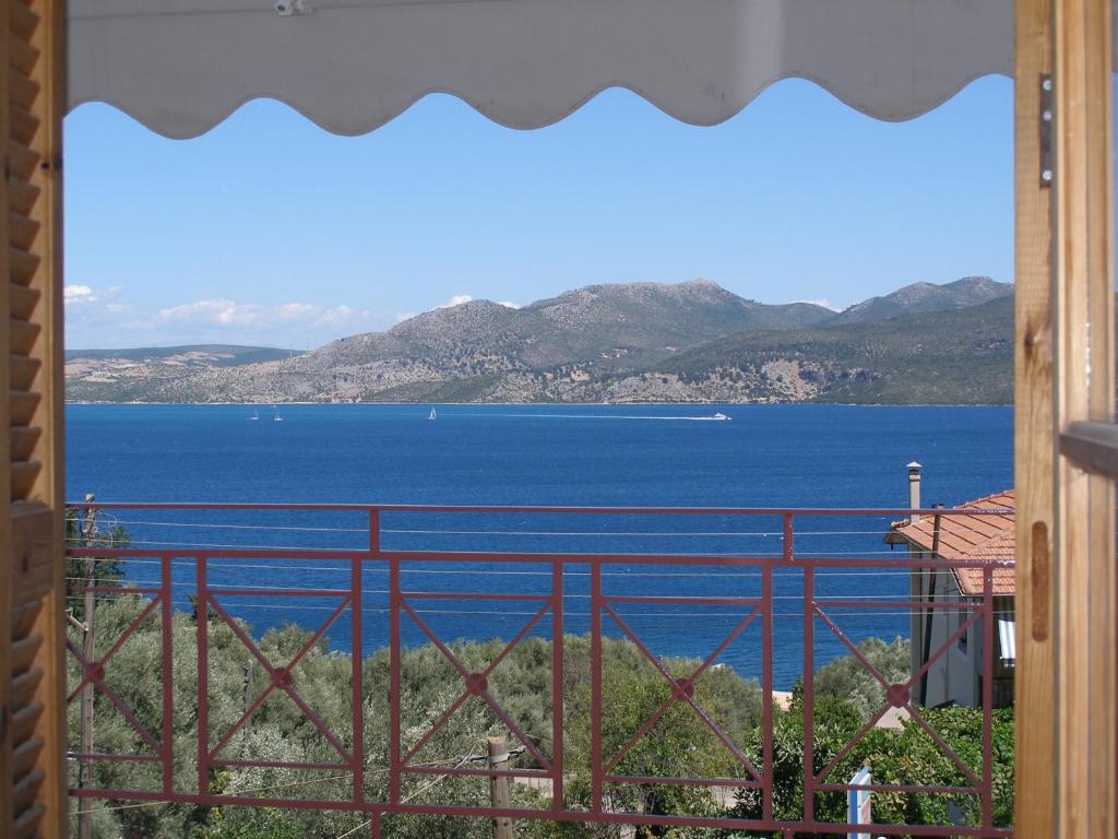 a view of a large body of water from a balcony at Christianna Studios in Nikiana