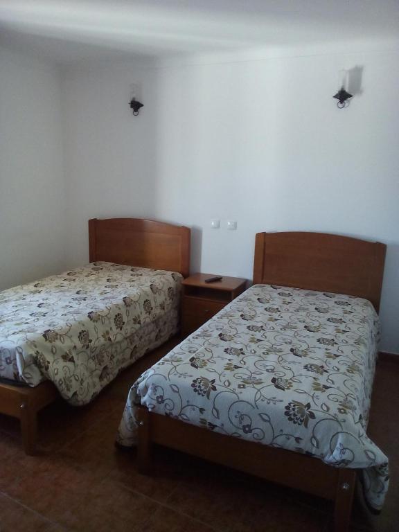 two beds sitting next to each other in a room at A Casa in Portel