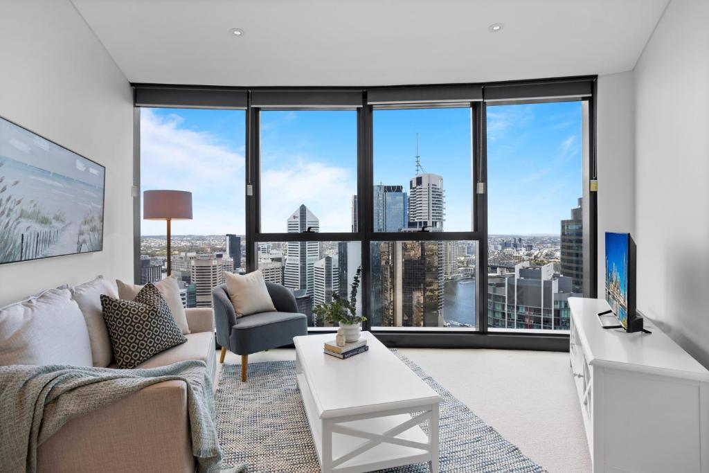 a living room with a view of a city at Breathtaking City Views 1-Bed with Pool, BBQ & Gym in Brisbane