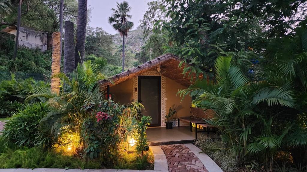 a house in the middle of a forest with lights at Pandu Pokhar Eco Adventure Resort in Rājgīr