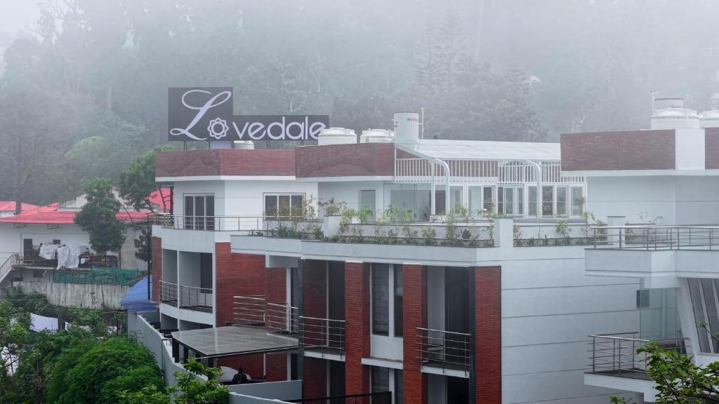 a building with a sign on the side of it at The Lovedale Kodaikanal Stay & Hotel in Kodaikānāl