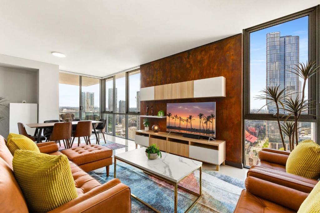 Central 2-Bed with Parking & Stunning Views في سيدني: غرفة معيشة في شقة بها تلفزيون وطاولة