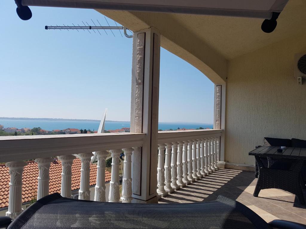 a balcony with a view of the ocean at Elizabeta Apartments in Nin