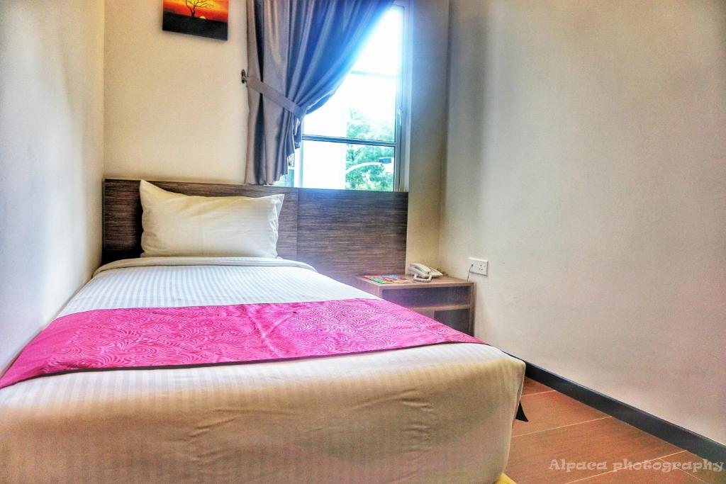 Postel nebo postele na pokoji v ubytování Nex Hotel Johor Bahru