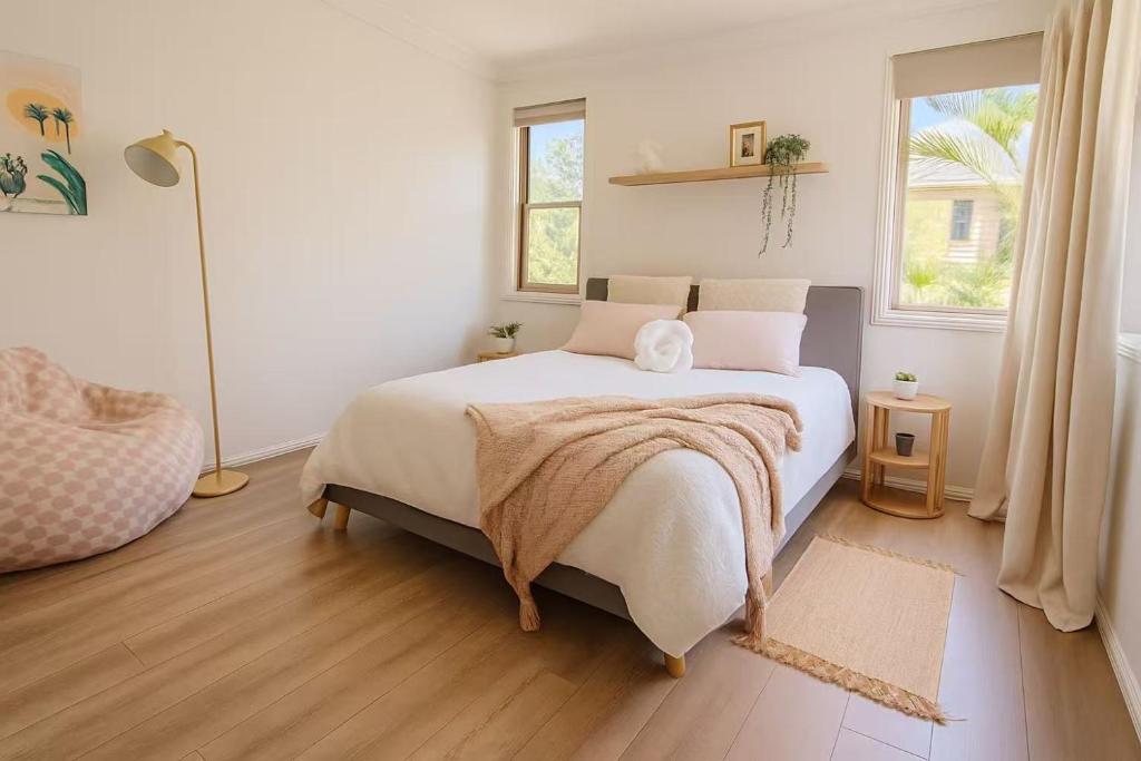 a bedroom with a bed with a blanket on it at Harbour Town Cozy Suite in Gold Coast