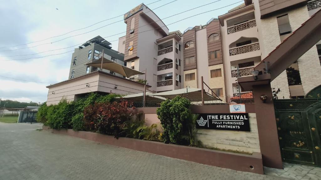 ein Gebäude mit einem Schild davor in der Unterkunft The Festival Fully Furnished Apartments in Mombasa