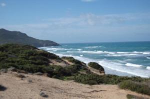 uma vista para o oceano a partir de uma praia arenosa em Il Pozzo Dei Desideri em Arbus