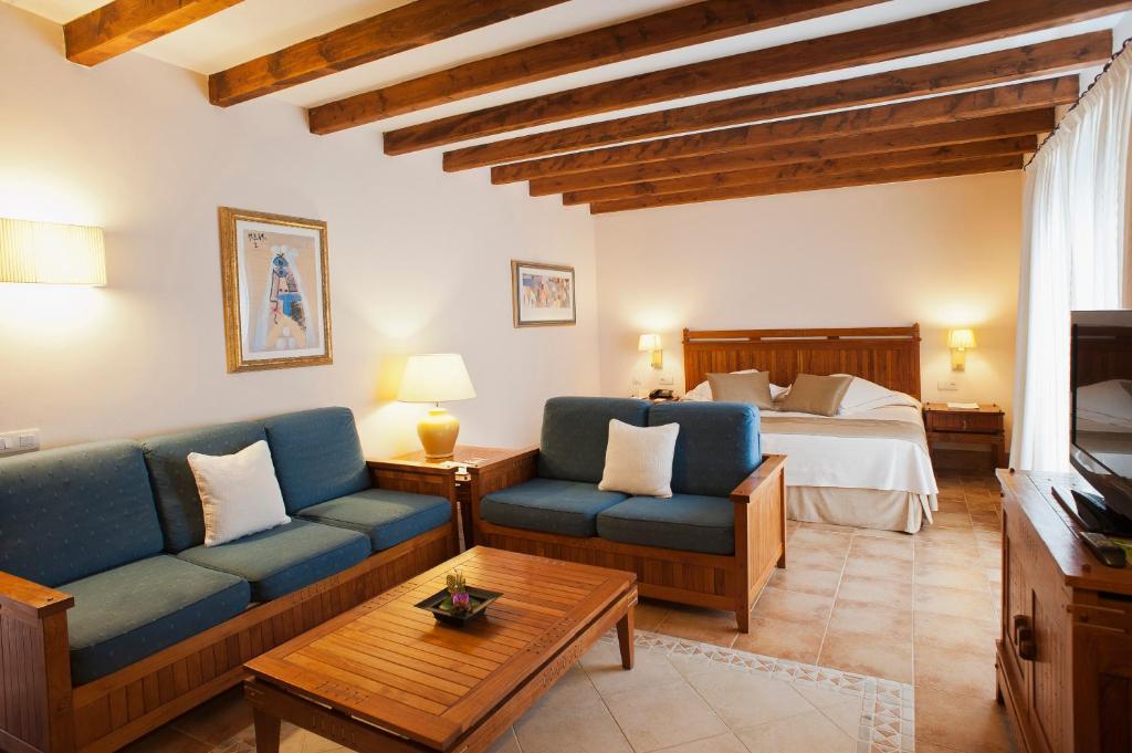 a living room with a couch and a bed at Princesa Yaiza Suite Hotel Resort in Playa Blanca