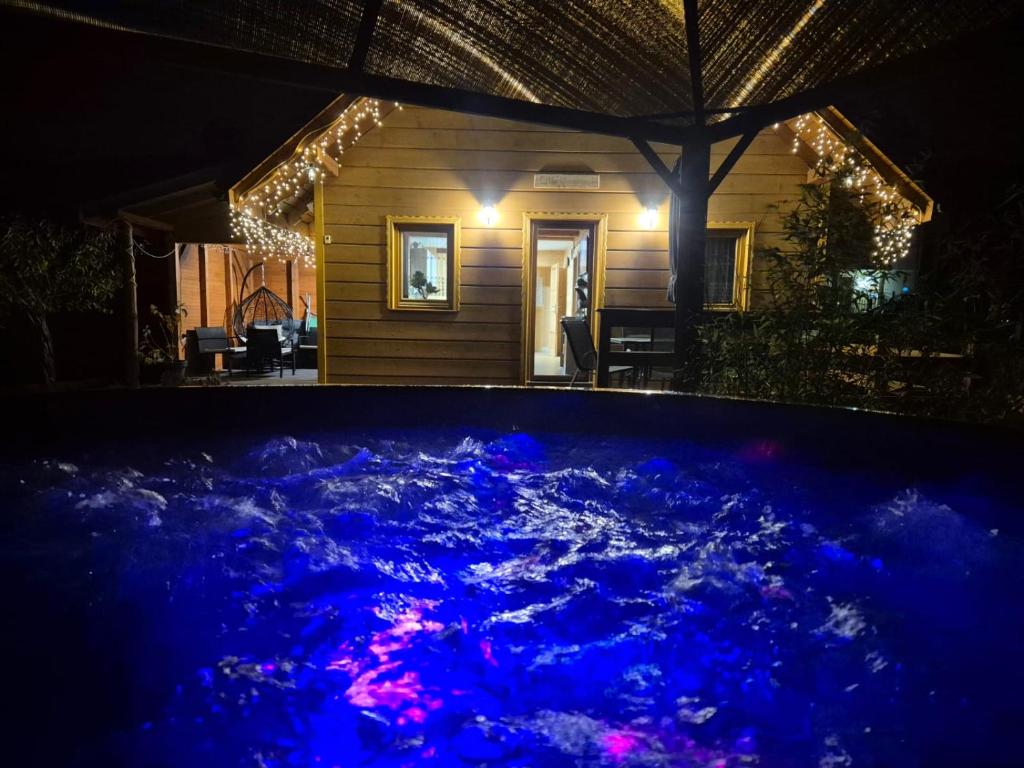 una piscina con luci blu davanti a una casa di Domki U Uli a Wisła