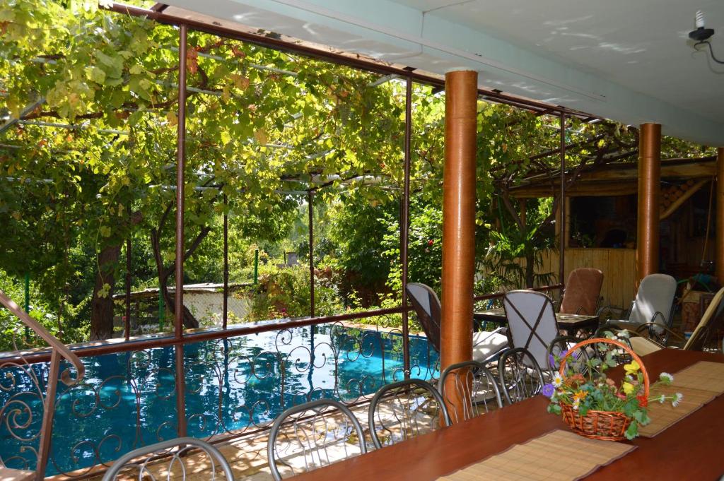 a balcony with a pool and a table and chairs at Gohar`s Guest House in Yeghegnadzor
