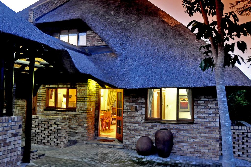 a house with a thatched roof at Legend Safaris 257A - in Kruger Park Lodge in Hazyview