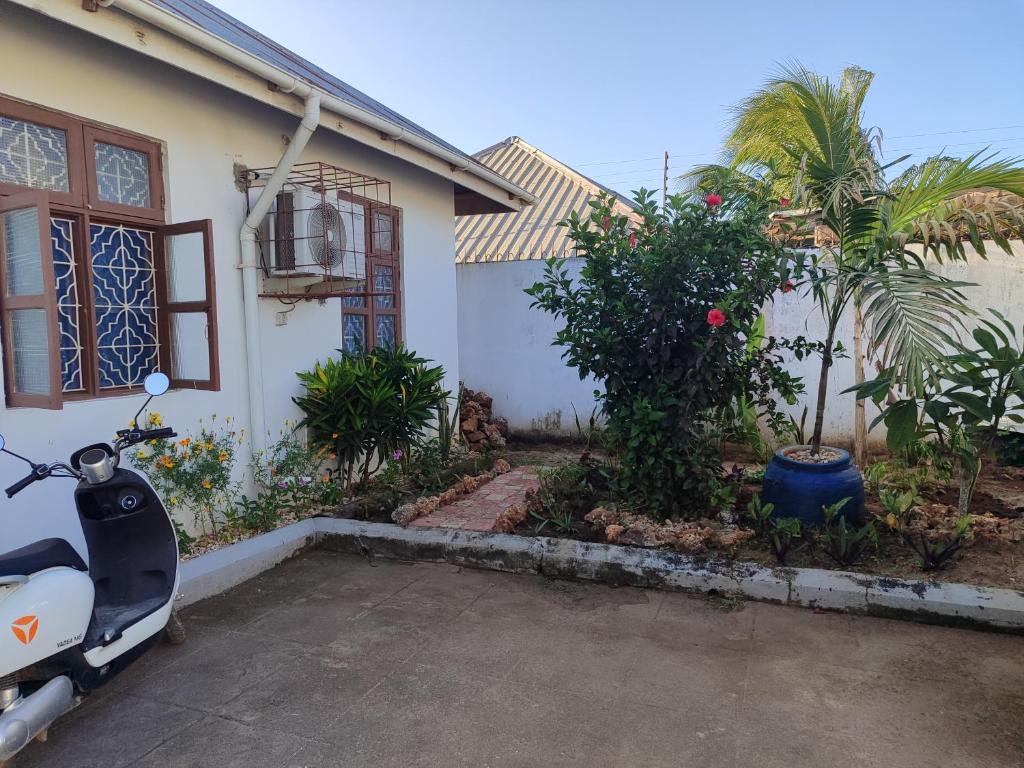 a scooter parked in front of a house at Kwa Mzungu Villa in Nungwi
