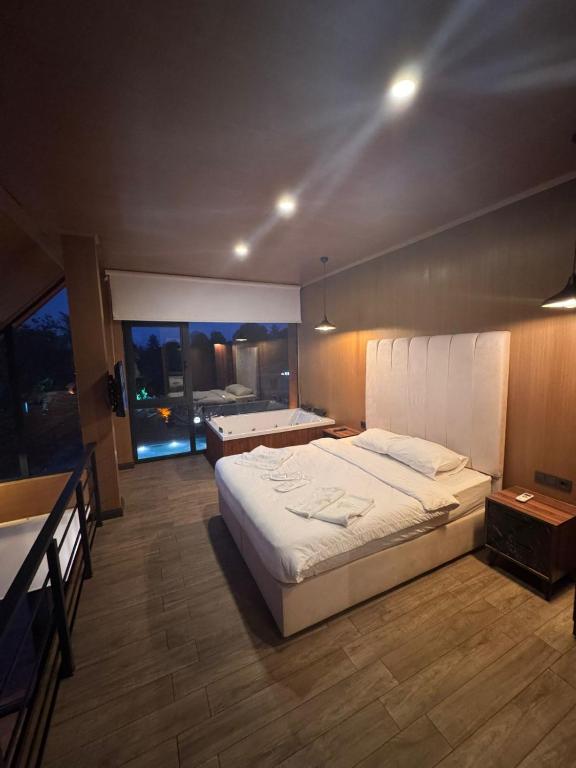 a bedroom with a large bed and a large window at Real Love Villas in Sapanca