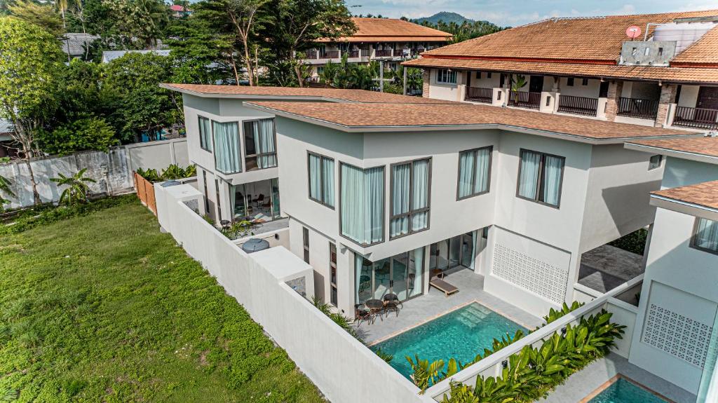 an aerial view of a house with a swimming pool at Modern 3 Bed Pool Villa Chaweng -Whispering Palm Villa A in Bang Rak Beach