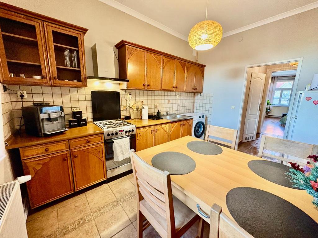 a kitchen with a wooden table and a dining room at Kawka i herbatka in Zielona Góra