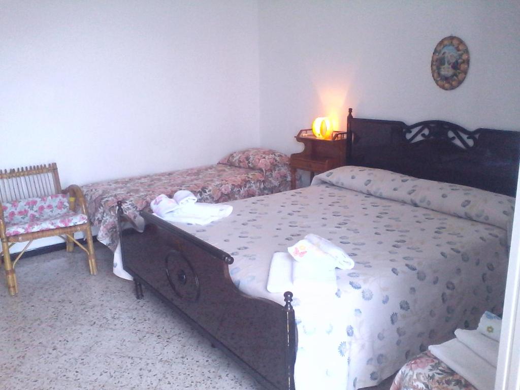 a bedroom with two beds and a table and a chair at Appartamento Andrea in Ravello