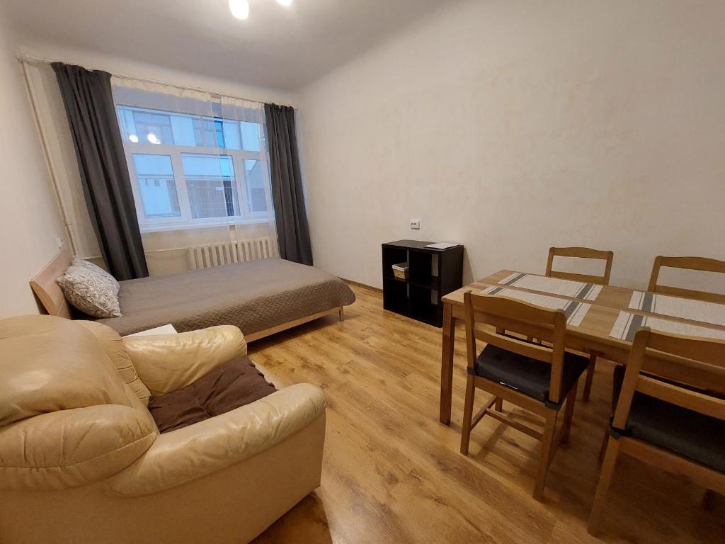 a living room with a bed and a dining room at Comfy apartment with 2 bedrooms in Riga