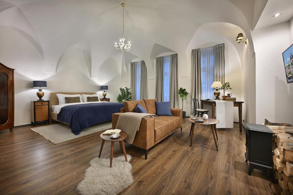 a living room with a bed and a couch at U Šuterů Boutique Hotel in Prague