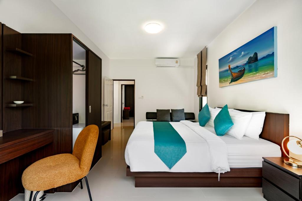 a bedroom with a bed and a desk and a chair at Baan Piengfah Holiday Home Ao Nang in Ao Nang Beach