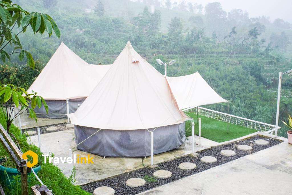 a teepee tent with a view of a valley at Sun CampGround in Kejajar
