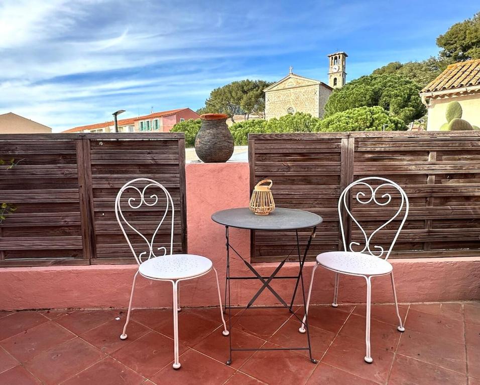 two chairs and a table on a patio at Chez Tao in Carqueiranne