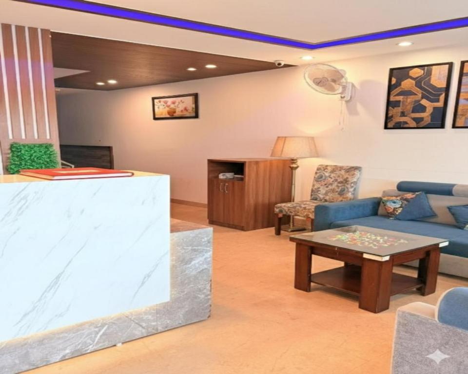 a living room with a couch and a table at Hotel Melano Ambala Chandigarh Rd Zirakpur SkyJumper park in Zirakpur