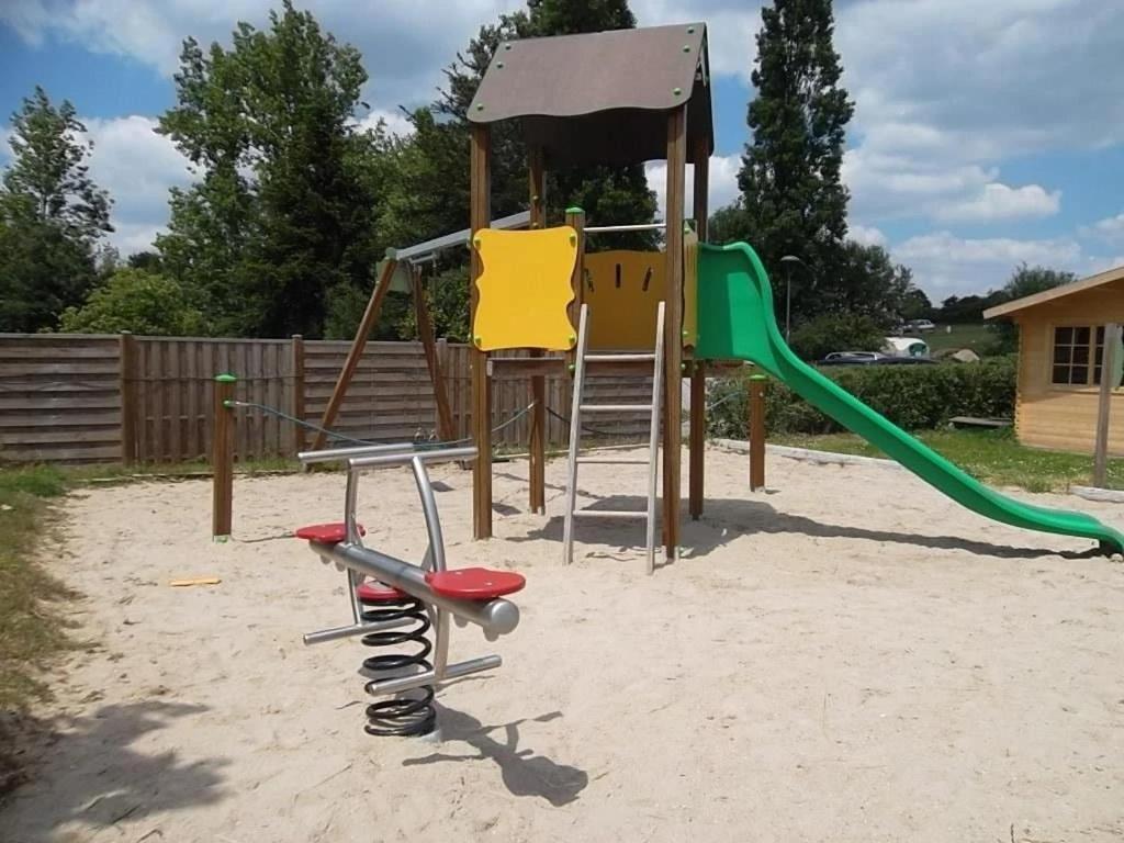 a playground with a slide and a swing at ZEcamping 3 étoiles animé animaux acceptés familial piscine couverte in Avrillé