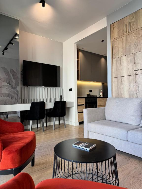 a living room with a couch and a table at BW Lux Apartments in Sajmište