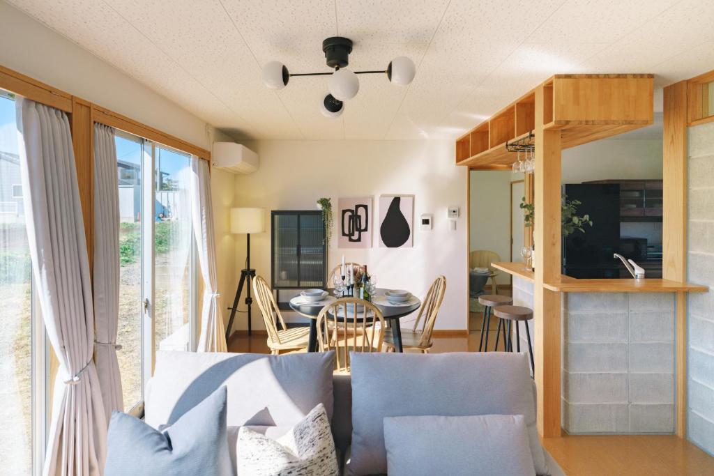 a living room with a couch and a table at 阿蘇ビューテラス in Aso