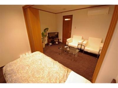 Postel nebo postele na pokoji v ubytování Sakura Hotel Oami
