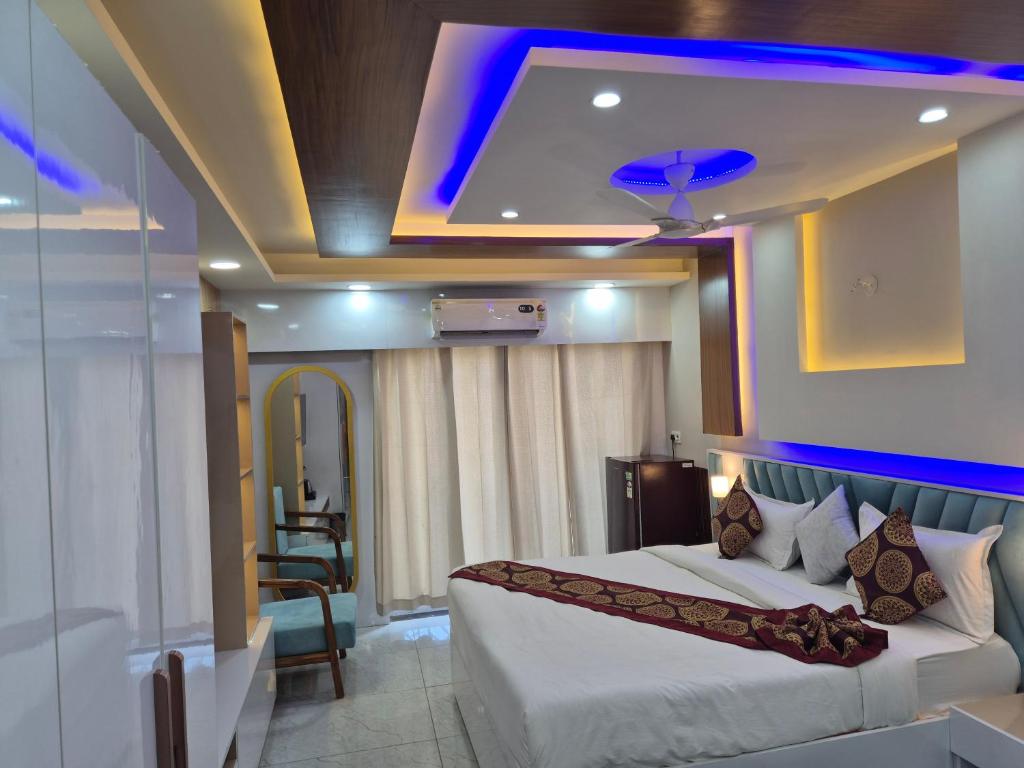 a hotel room with a bed and a blue light at Hotel Grand Luxury Char Dham in Vrindāvan