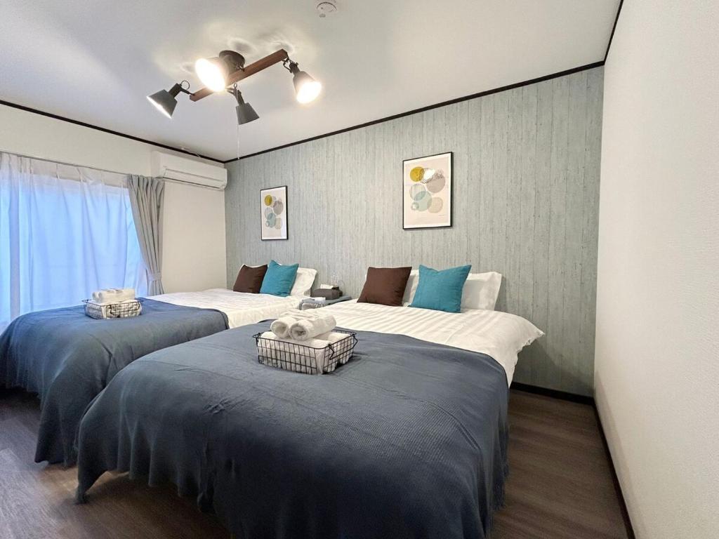 Ένα ή περισσότερα κρεβάτια σε δωμάτιο στο KENDAMA 5 minutes to Namba!USJ 30 minutes! Great as a base for sightseeing in Osaka!Accommodation for up to 10 people Private station is a 3-minute walk